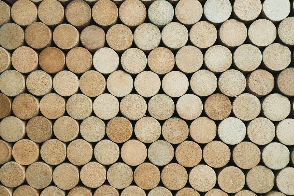 Close-up of stacked wooden cylinders creating a patterned texture.